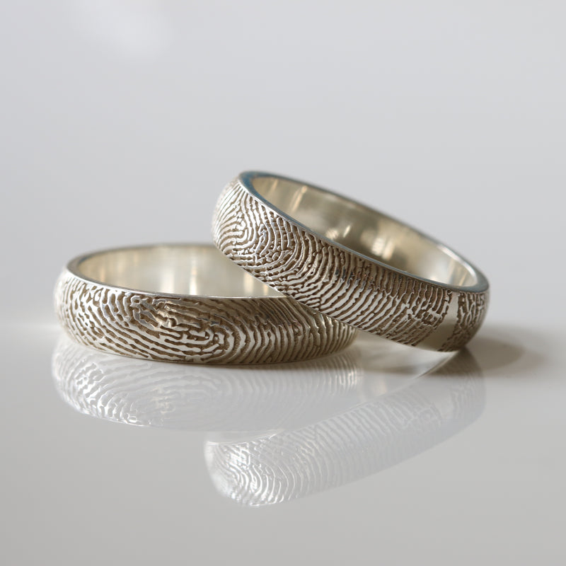 Silver fingerprint rings with engraved bands