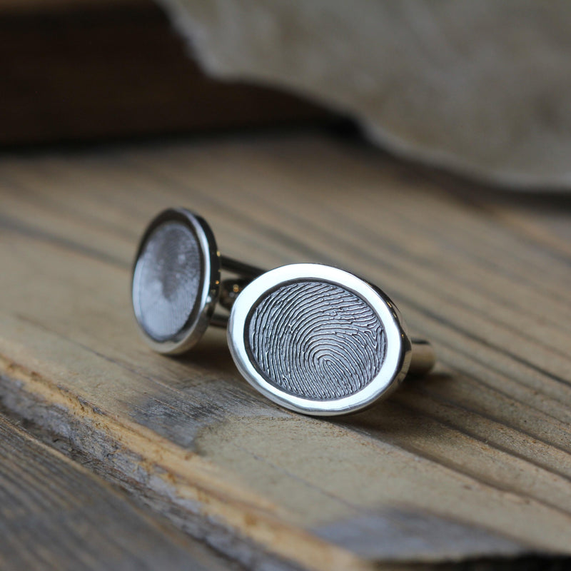 Oval fingerprint cufflinks showing the silver frame and fitting