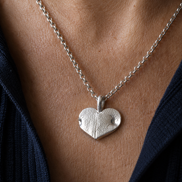 Silver Snozza Wide Heart Dog Nose Impression Necklace worn on a sterling silver chain. Large size shown.