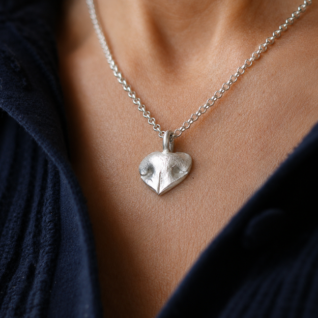 Silver Snozza Regular Heart Necklace worn to show the pendant clearly.