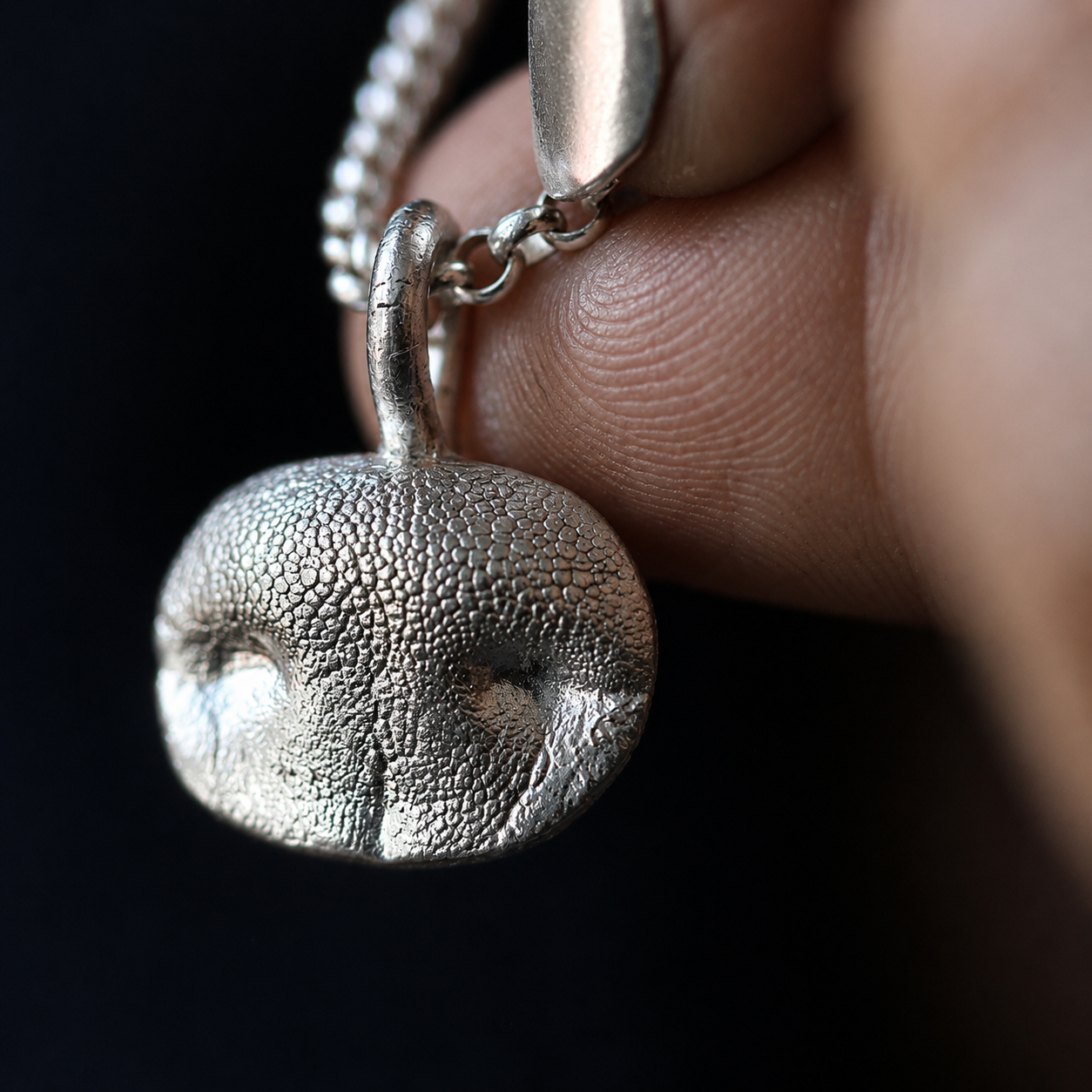 Silver Snozza Oval Dog Nose Impression Necklace handcrafted from a life-size impression of unique dog nose texture.