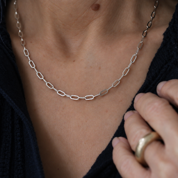 Sterling silver paperclip chain, 2.43 mm wide, worn at the neck