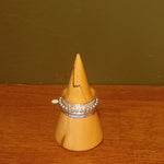 Textured spinner ring with one ball wire and one plain spinning rings