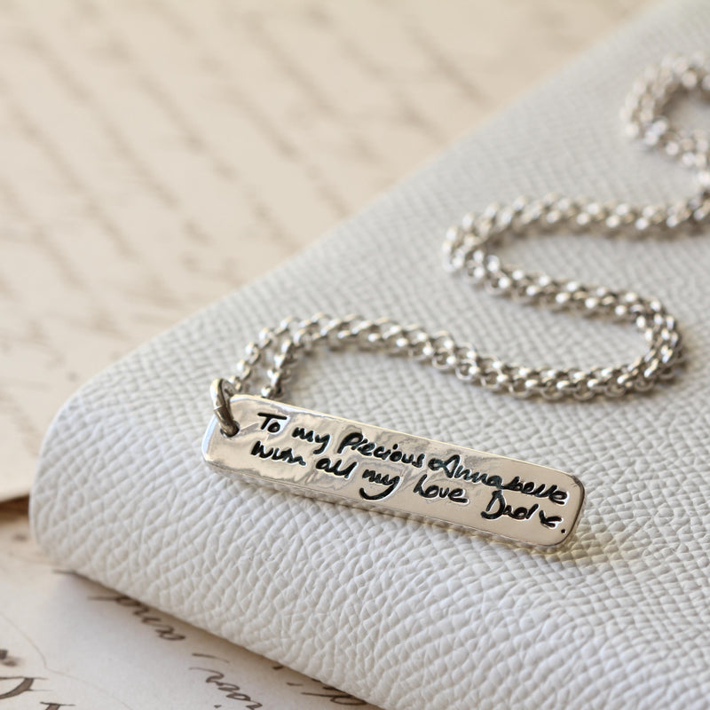 Handwritten lettering reproduced on a silver ingot pendant