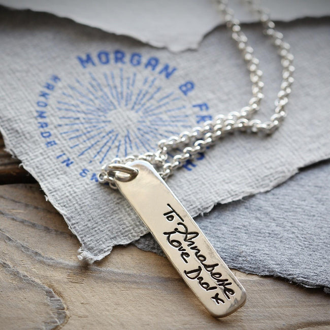 Silver handwriting ingot pendant on a chain