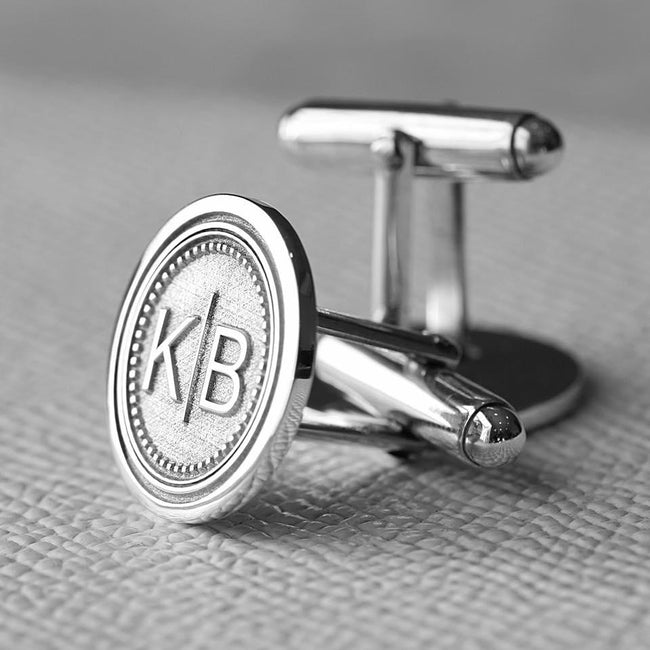 Silver monogram cufflinks showing the face and T-bar back