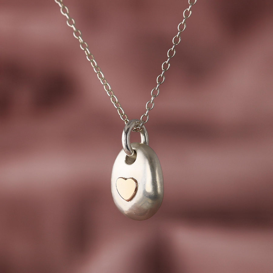 Silver Secret Chamber pebble pendant with a heart sealing the chamber