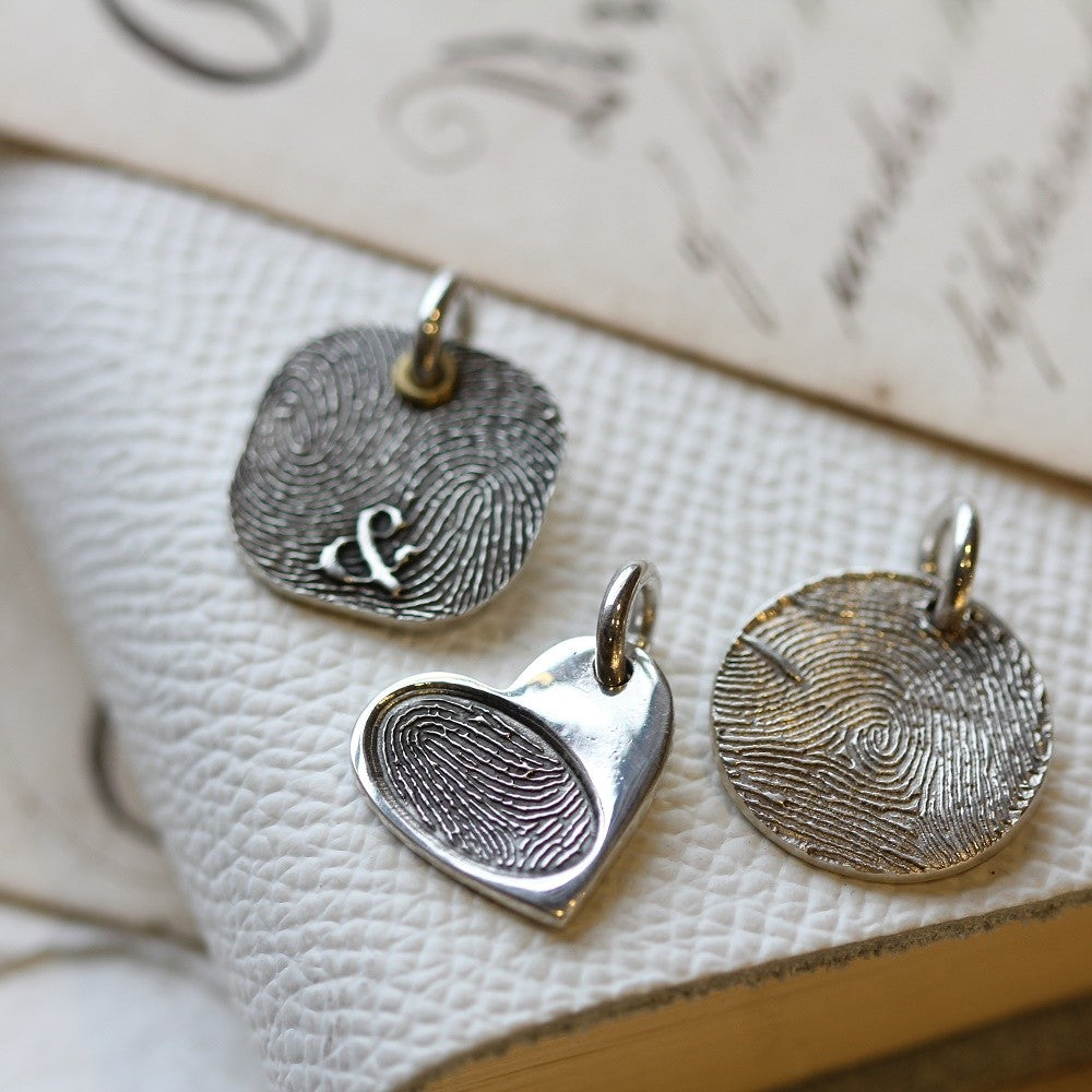 Round, Heart and rounded-square fingerprint charms displayed together